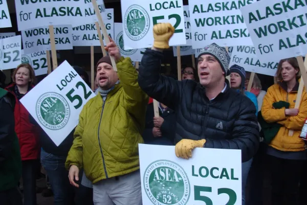 Workers rallying with signs that say Alaskans working for Alaska